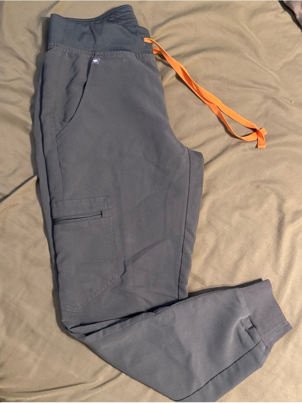FIGS Women’s Jogger scrubs in green with Orange Drawstring